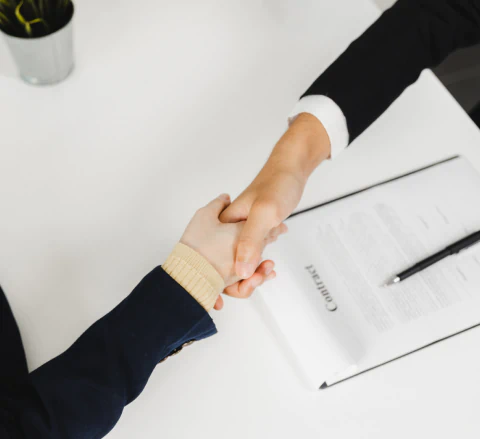 appraiser shaking hand with his client after a successful negotiating deal